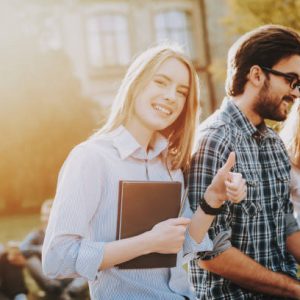 istockphoto-1051195608-612×612 Notebooks. Friendship. Girl. Look. Camera. Sit. Courtyard. University. Students. Architecture. Freelance. Hipster. Group of Young People. Study Together. Good Mood. Laptop. Textbooks. Have Fun.